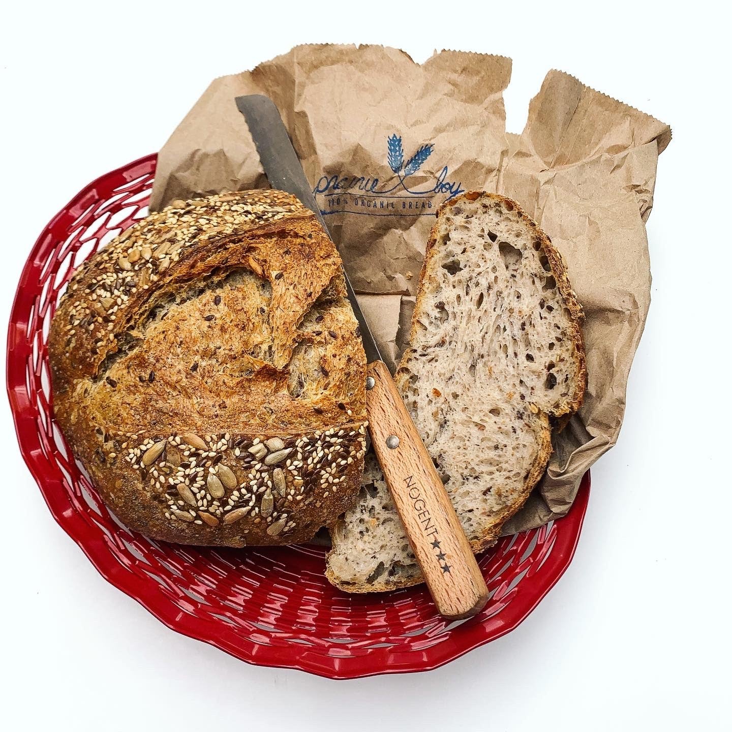 sourdough bread in red metallic bread basket