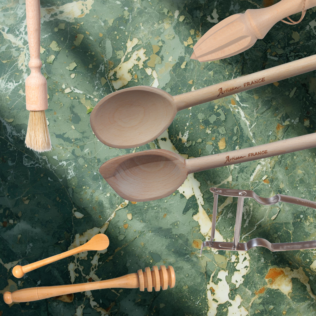 a hand holding kitchen utensils in wood