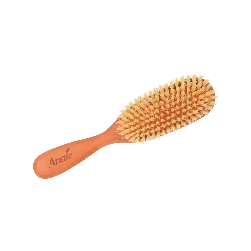 Wooden hairbrush with bristle head on a white background, Clementine Boutique