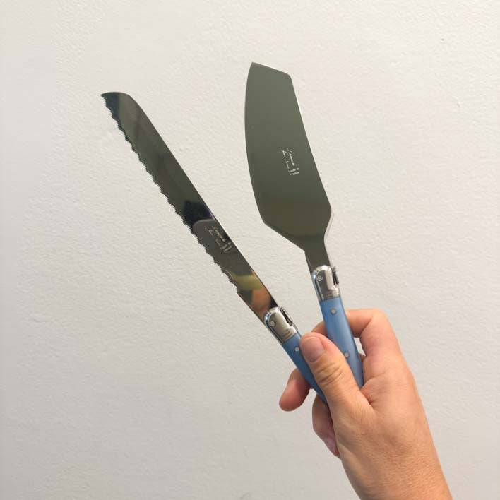 Hand holding Laguiole set of Bread knife and Cake server made in France, Clementine Boutique Made in France