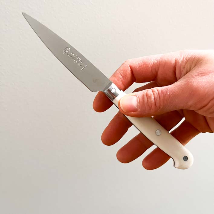 Hand holding a Kitchen Knife with Full Tang Blade & Cream Handle, La Fourmi, Made in France