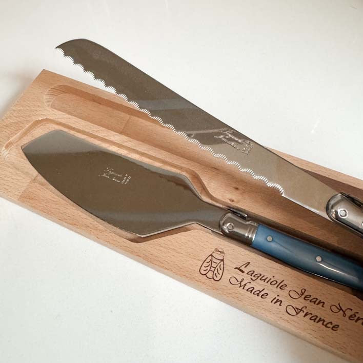 Laguiole Cake Slicer and Bread Knife Set, Pastel Blue Handles: serrated blade detail on white countertop