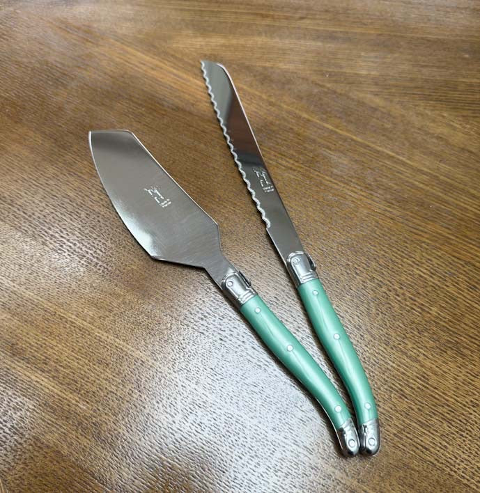 Laguiole Cake Slicer and Bread Knife Set, Pastel Green Handles on a wooden table