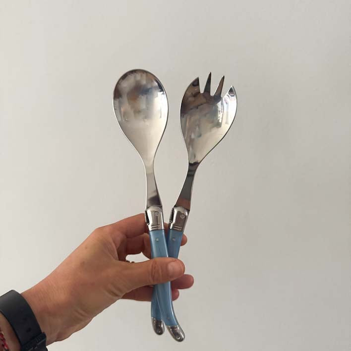 Hand hiolding a Laguiole Salad Server Set, Pastel Blue Handles